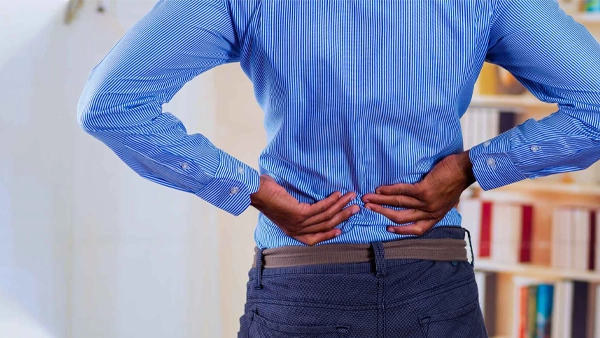 Chiropractic Anna TX Back pain HP Person holding their lower back, suggesting back pain.